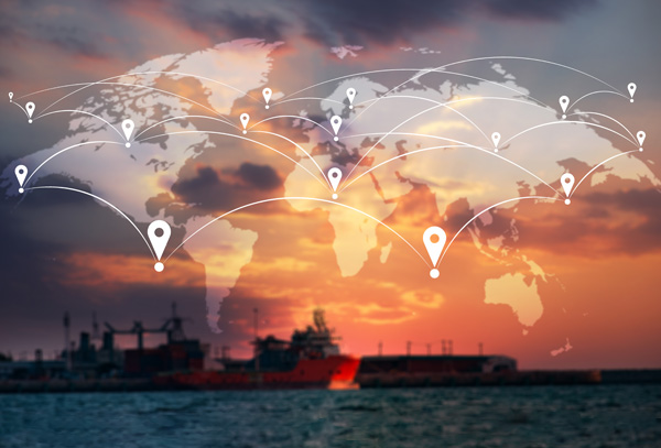 Connected global map graphic with location pin icons overlaid above a cargo port and ocean vessel at sunset.
