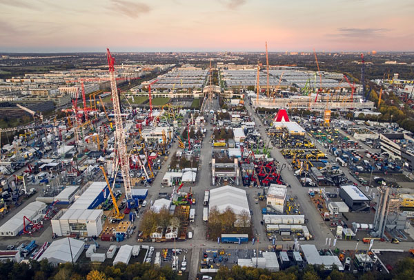 Panoramic view of the bauma trade fair outdoor exhibition area in Munich with industrial cranes and structures.