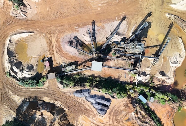 Aerial photograph of a quarry conveyor network and processing plant, illustrating bulk material handling infrastructure, stockpiles, access roads, and interconnected conveyor systems used in aggregate production.